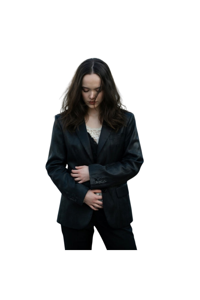 Woman wearing a black suit on a white background