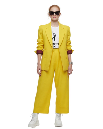 Person wearing a yellow suit with a white shirt underneath on a white background