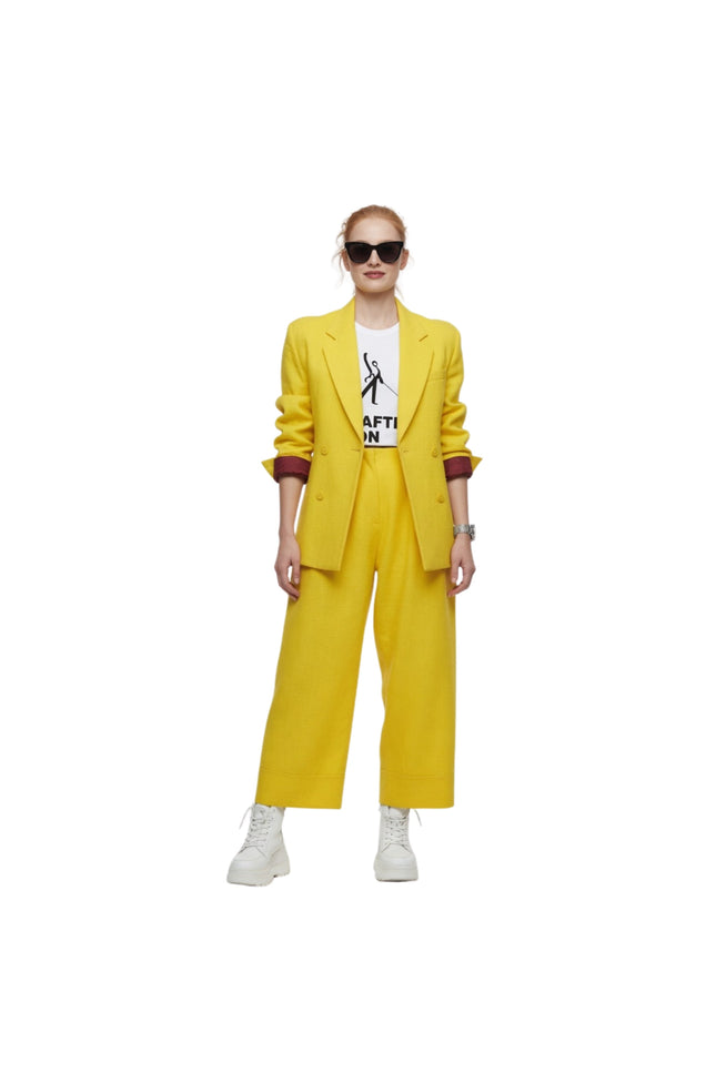 Person wearing a yellow suit with a white shirt underneath on a white background