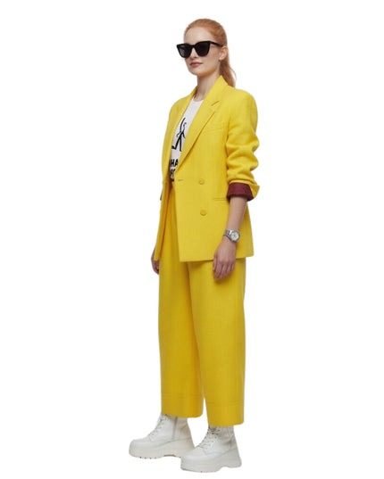 Person wearing a yellow suit with sunglasses on a white background