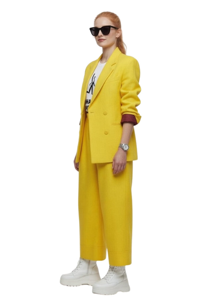 Person wearing a yellow suit with sunglasses on a white background