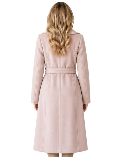 Woman wearing a long pink coat on a white background