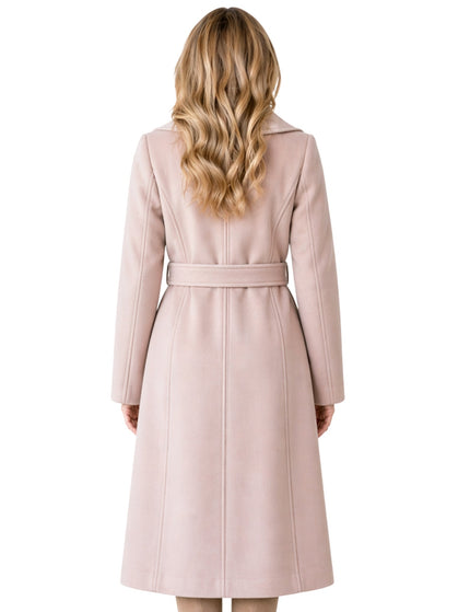 Woman wearing a long pink coat on a white background
