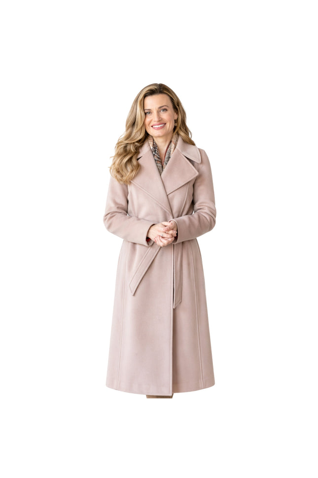 Woman wearing a light pink coat on a white background