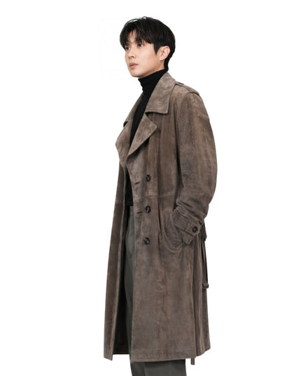 Man wearing a brown trench coat on a white background