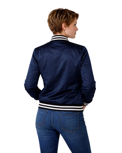Person wearing a navy blue bomber jacket with white stripes on a white background