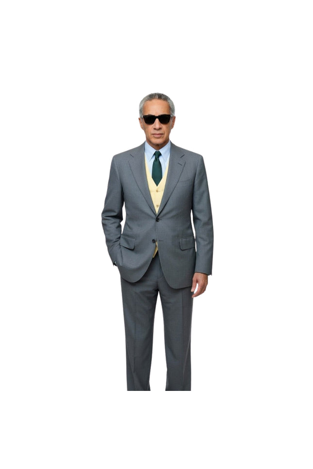 Man wearing a gray suit with a green tie on a white background