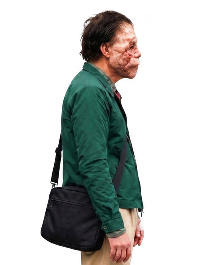 Man wearing a green jacket with a black bag on a white background