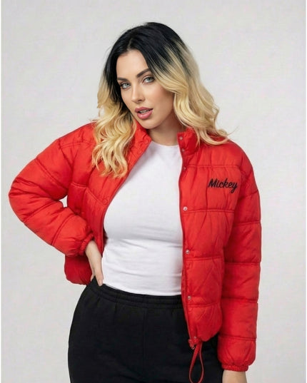 Woman wearing a red puffer jacket with 'Mickey' branding on a plain background