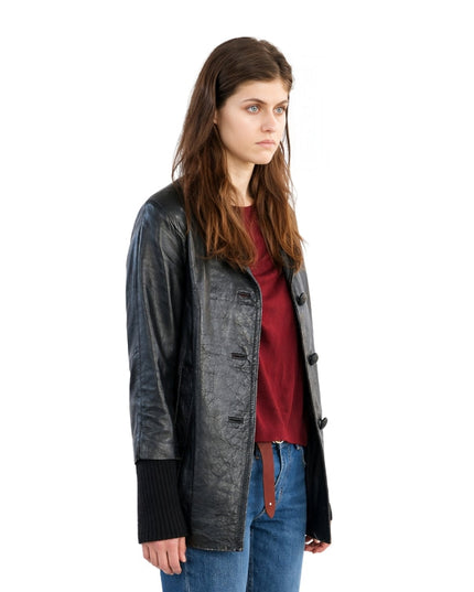 Woman wearing a black leather jacket over a red shirt on a white background