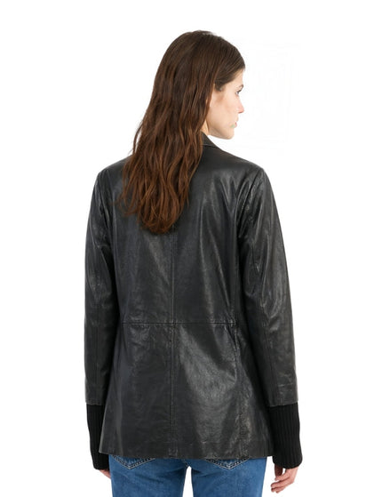 Woman wearing a black leather jacket on a white background
