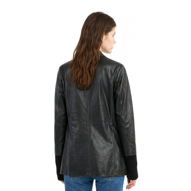 Woman wearing a black leather jacket on a white background