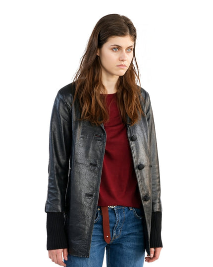 Woman wearing a black leather jacket over a red shirt and blue jeans on a white background