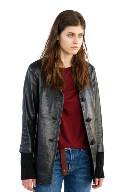 Woman wearing a black leather jacket over a red shirt and blue jeans on a white background