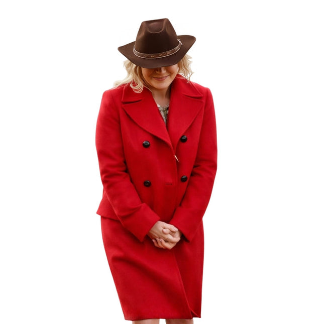 Person wearing a red coat and brown hat on a white background