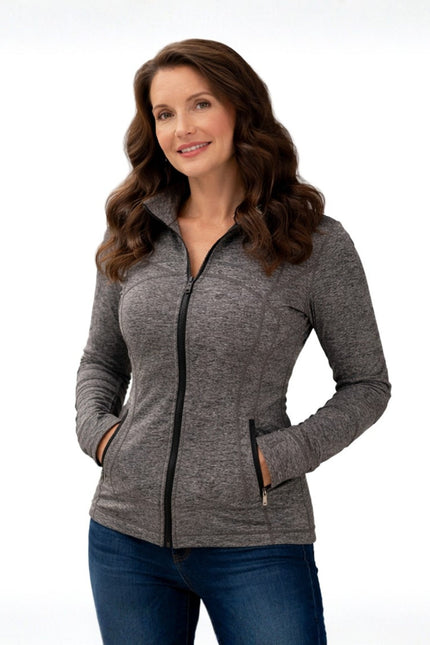 Woman wearing a gray zip-up jacket on a white background