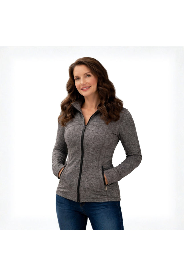 Woman wearing a gray zip-up jacket on a white background