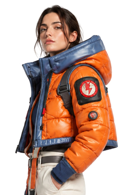 Person wearing an orange and blue jacket with a backpack on a white background