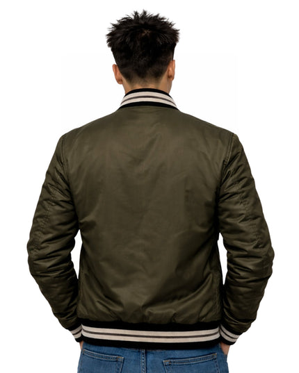 Person wearing a green bomber jacket on a white background