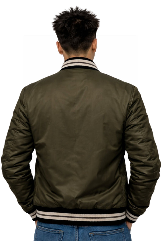Person wearing a green bomber jacket on a white background