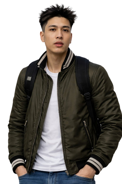 Man wearing a green bomber jacket with a white shirt and blue jeans on a white background
