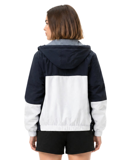Person wearing a two-tone jacket with navy and white colors on a white background