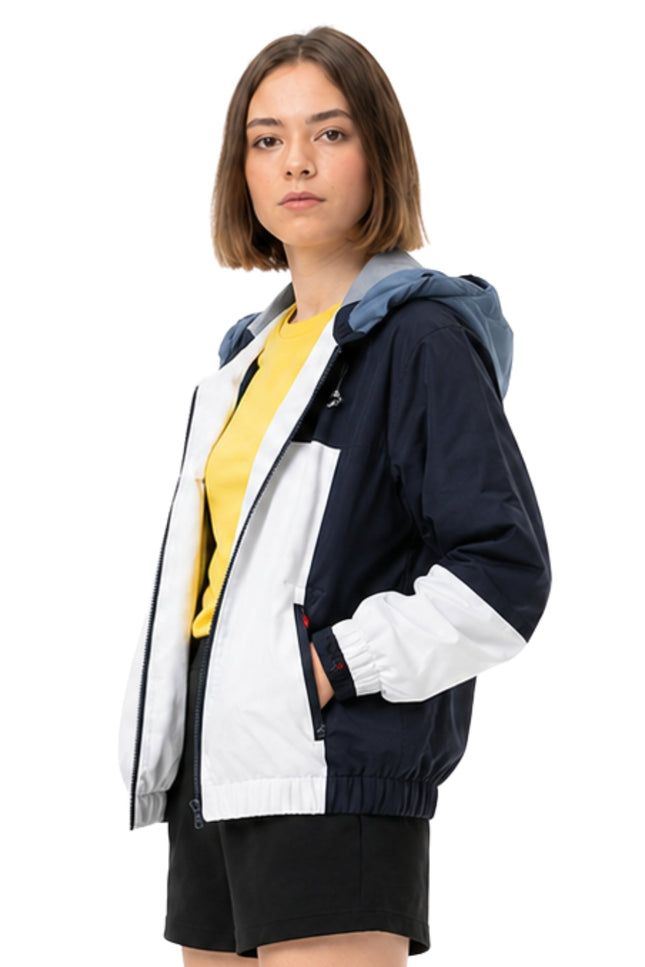 Woman wearing a colorful jacket with a white background