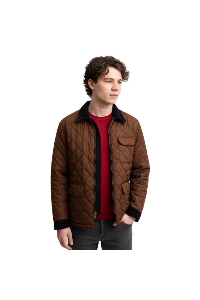 Man wearing a brown quilted jacket over a red shirt on a white background