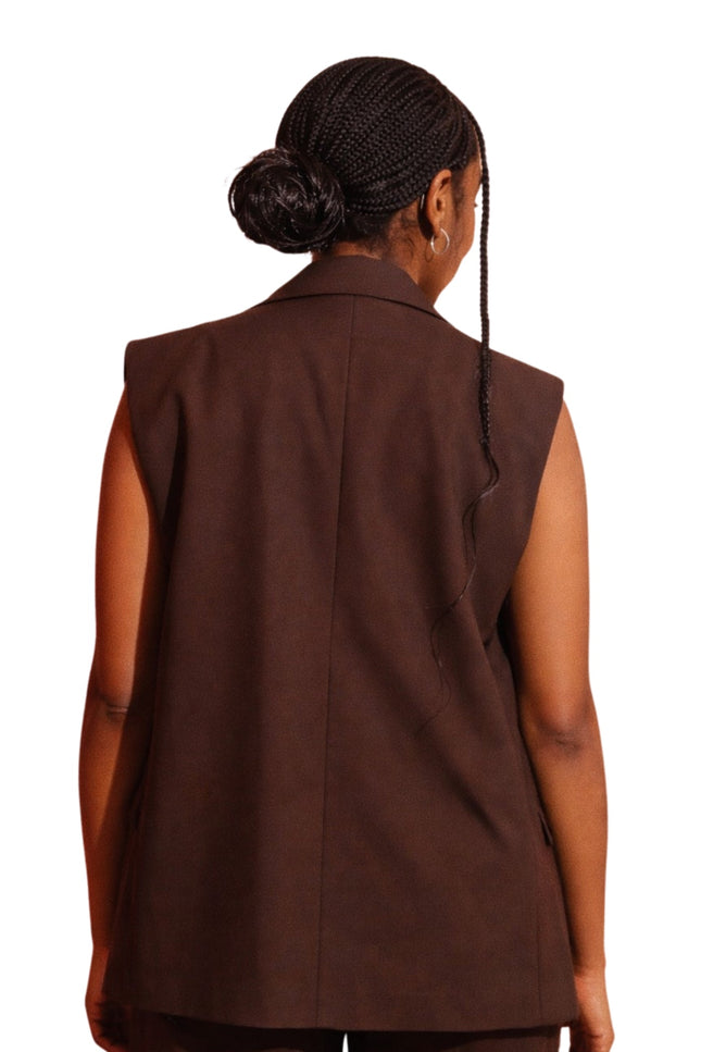 Brown vest worn by a person on a white background