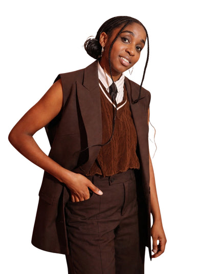 Woman wearing a brown vest and pants set on a white background