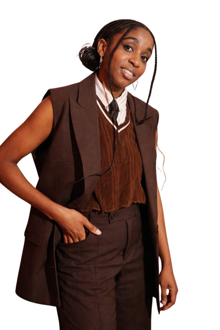 Woman wearing a brown vest and pants set on a white background