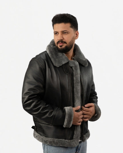 Man wearing a black leather jacket with gray fur lining on a white background