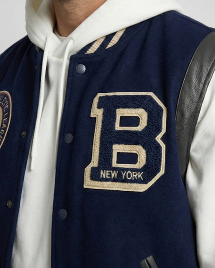 Navy varsity jacket with a large 'B' emblem on a white background
