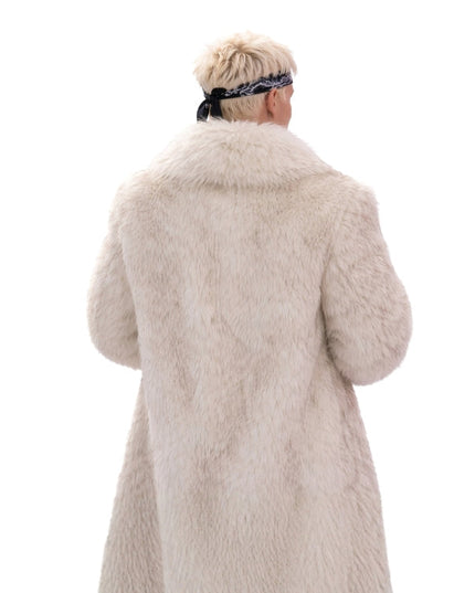Person wearing a beige fur coat on a white background