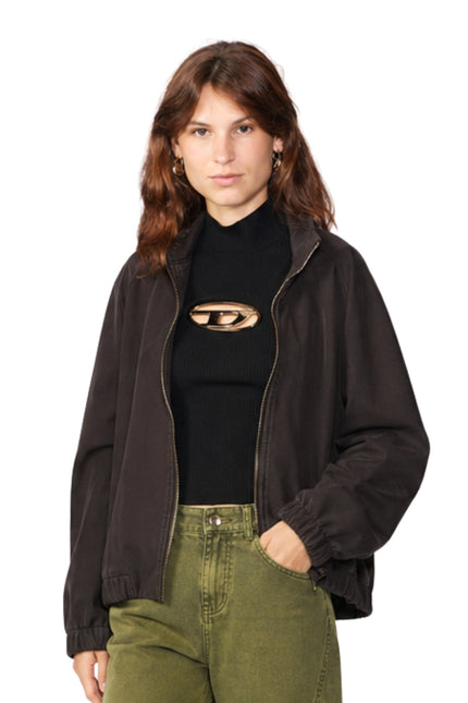 Woman wearing a black jacket and black top with cut-out design on a white background