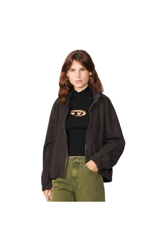 Woman wearing a black jacket and black top with cut-out design on a white background
