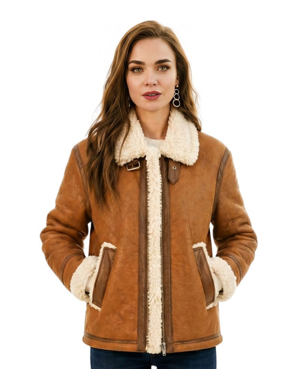Woman wearing a brown shearling jacket with white fur lining on a white background