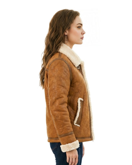 Woman wearing a brown shearling jacket with white fur lining on a white background