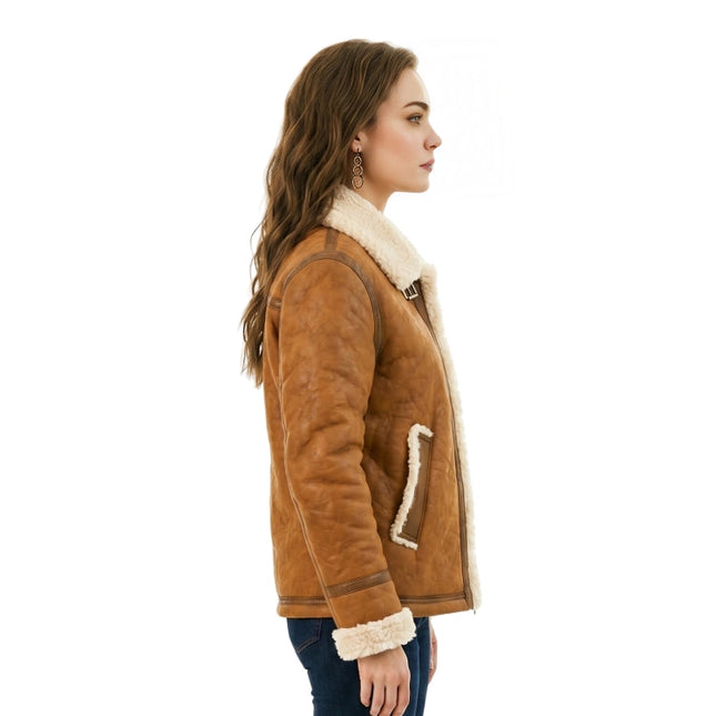 Woman wearing a brown shearling jacket with white fur lining on a white background