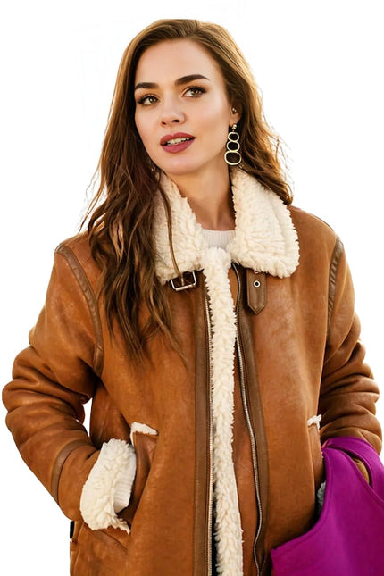 Woman wearing a brown shearling coat with white fur lining on a white background