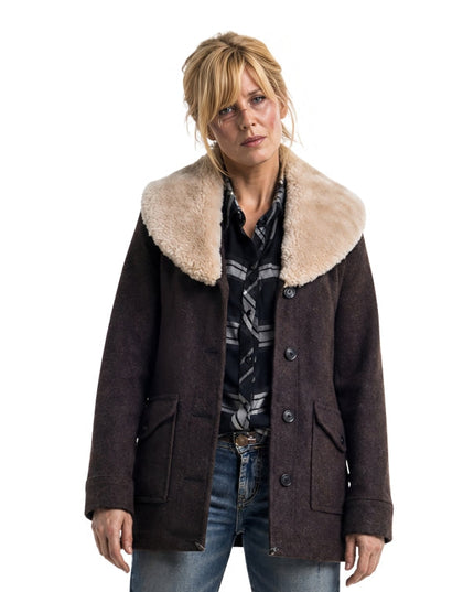 Woman wearing a brown coat with a fur-lined collar on a white background