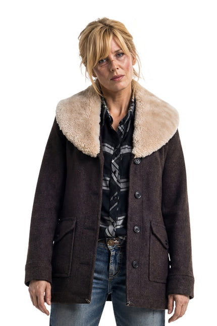 Woman wearing a brown coat with a fur-lined collar on a white background