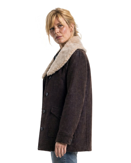 Woman wearing a brown coat with a fur collar on a white background