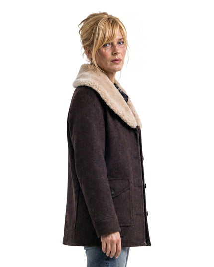 Woman wearing a brown coat with a fur-lined hood on a white background