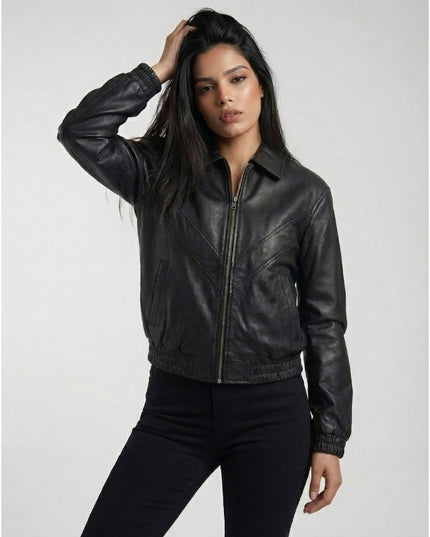 Woman wearing a black leather jacket against a plain background