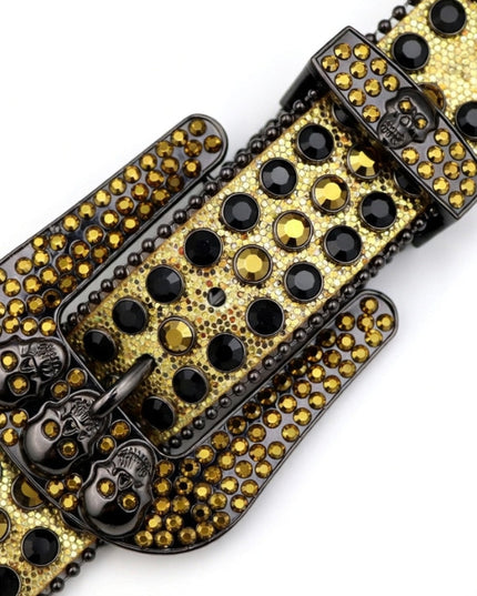 Gold and black studded belt buckle on a white background