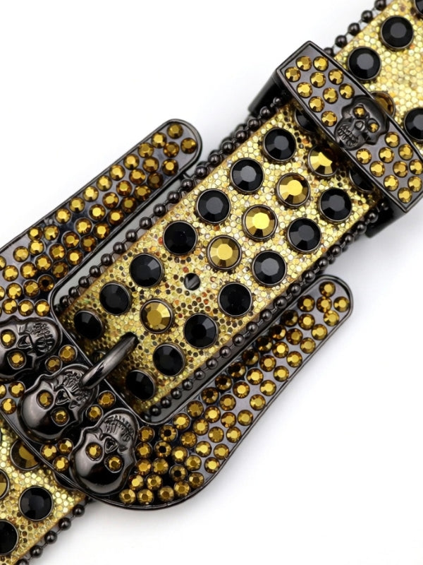 Gold and black studded belt buckle on a white background