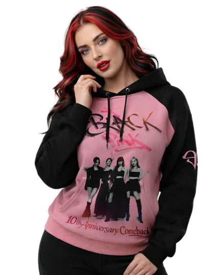 Person wearing a pink and black hoodie with graphic design and text