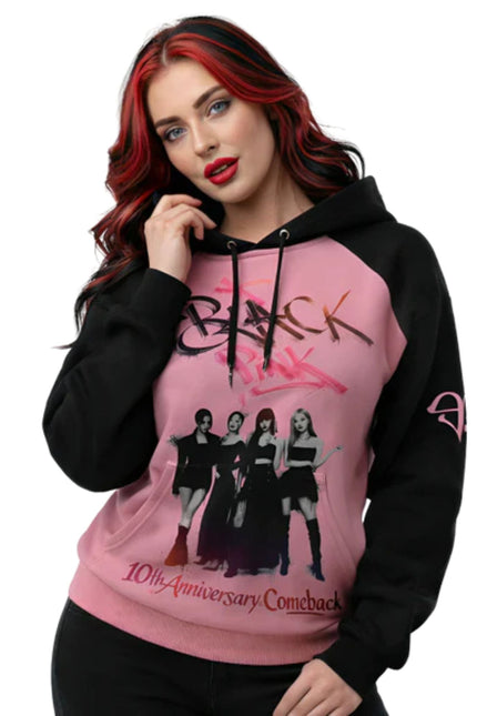 Person wearing a pink and black hoodie with graphic design and text