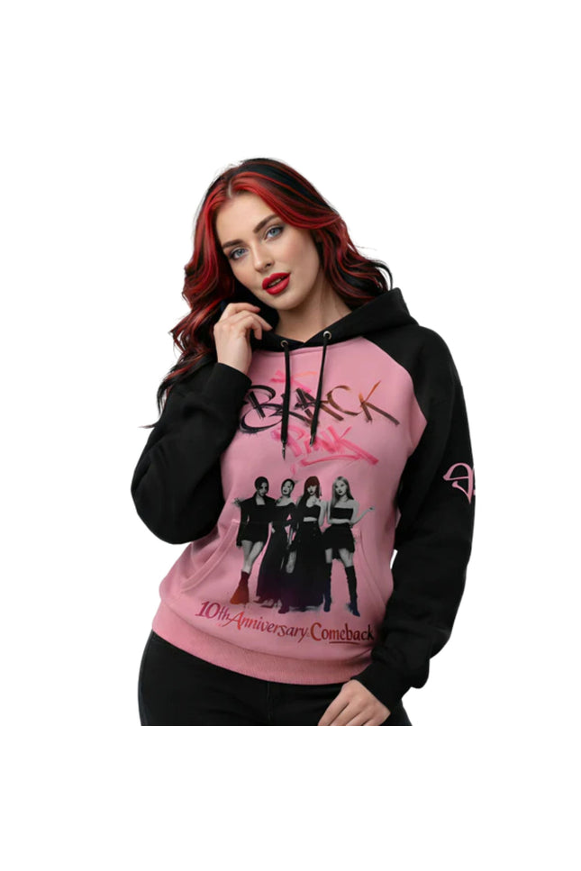 Person wearing a pink and black hoodie with graphic design and text